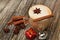 Cappuccino and cookie with star ansie and cinnamon stick Jingle bell and gift