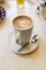 Cappuccino cup on the brown wooden table