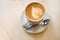 Cappuccino cup on the brown wooden table