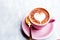 Cappuccino cup with heart latte art on marble table background
