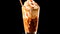 cappuccino, elegantly presented in a transparent glass with a swirl of whipped cream and a drizzle of caramel