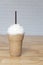 Cappuccino frappe on wooden table