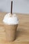 Cappuccino frappe on wooden table