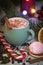Cappuccino in green mug with christmas decoration and candies. Marshmallow and candy