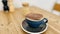 A Cappuccino with grey cup on wooden table.