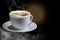 Cappuccino or Latte Coffee. Latte coffee with foam sprinkled with caramel brown granules, in a white cup, isolated in dark shades