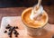 Cappuccino milk foam with coffee beans on table background