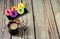 Cappuccino mug and plate with five donuts in multicolored glaze on a wooden table