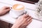 Cappuccino in a white ceramic cup and saucer on a white wooden bench