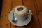 Cappuchino coffee in white porcellan cup and saucer with spoon