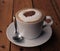 Cappuchino coffee in white porcellan cup and saucer with spoon
