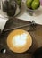 Cappucino coffee with tulip latteart style which put on brown wood