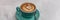 Cappucino latte art coffee cup banner background for cafe. Panoramic header crop of hot espresso coffee drink