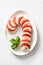 Caprese candy cane salad is holiday appetizer on white