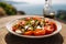 a Caprese salad, with a blurred backdrop of the beautiful Amalfi Coast.