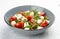 Caprese salad, cherry tomatoes, mozzarella, arugula and pesto sauce. Isolated image