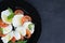 Caprese salad on a large black plate