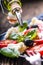 Caprese Salad.Mediterranean salad. Mozzarella cherry tomatoes basil and olive oil on old oak table. Italian cuisine