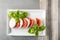 Caprese salad with mozarella cheese, tomatoes and basil