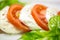 Caprese salad with mozarella cheese, tomatoes and basil