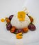 A caprese salad with mozzarella cheese made with donkey\\\'s milk, colored cherry tomatoes and basil, all on a white plate