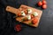 caprese salad skewer with tomato on sticks Italian traditional caprese salad ingredients. Mediterranean food. over black stone