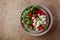 Caprese salad with tomato, mini mozzarella and basil on a brown background