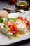 Caprese salad with tomatoes, basil, mozzarella balls, made with