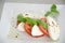 Caprese salad with tomatoes, basil and mozzarella on the table of stainless steel