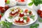 Caprese toasts with mini mozzarella cheese, cherry tomato and basil