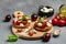 Caprese toasts with mozzarella, cherry tomatoes and fresh garden basil. Traditional italian appetizer or snack