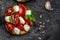 Caprese toasts with mozzarella, cherry tomatoes and fresh garden basil. Traditional italian appetizer or snack, antipasto. top