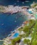 CAPRI, ITALY, 1965 - The boats rock gently in the blue, quiet sea of Marina Piccola