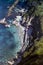 CAPRI, ITALY, 1965 - The sea bathes the beach of Bagni di Tiberio, between the bathing establishment, the cliff and the Roman