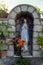 CAPRI, ITALY, 1983 - A small statue of the Madonna blesses passers-by along a street in Anacapri