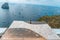 Capri, Italy - August 13, 2019: Bronze sundial on marble horlogue with view of faraglioni in Tyrrhenian sea