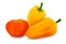 capsicum Harvest Yellow Colored bell peppers and orange tomato over white background