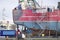 Capsized ship vessel and rescue lift crane at port dock for repair of shipwreck