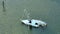 Capsized sunken sailing boat left forsaken on shallow bay waters after hurricane Ian in Manasota, Florida