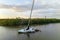 Capsized sunken sailing boat left forsaken on shallow bay waters after hurricane Ian in Manasota, Florida