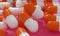 Capsule medicine pills, health pharmacy concept. Drugs for treatment medication. Heap of orange white color capsules on pink backg