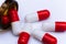 Capsule pills on white background, close-up of a drugs that could give addiction