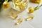 Capsules of evening primrose oil on a table - healthy nutritional supplement