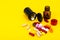 Capsules, pills on yellow background. Concept of health and pharmacology