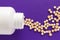 Capsules spilling out of white bottle. Purple background. Line,