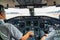 Captain and Co Pilot in a cockpit of a modern business jet while taxiing on a rainy day