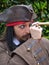 Captain Jack Sparrow. Cosplayer peers through telescope