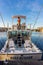 The captain prepares lures on a charter fishing vessel.