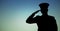 Captain silhouette saluted against blue green background
