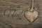 Caption in French Joyeux Noel in burnt letter script on wood with a heart